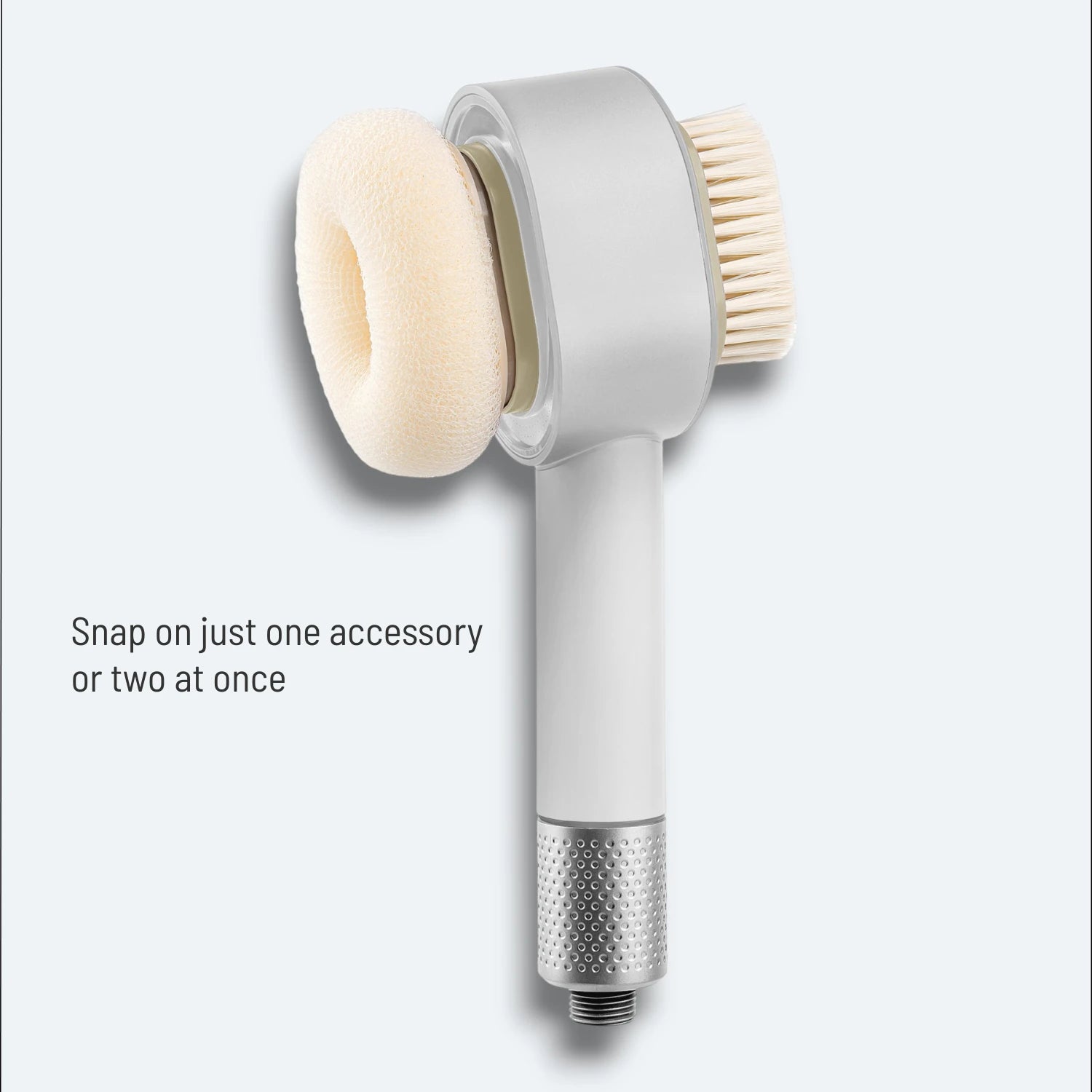 A shower head with attached magnetic snap-on exfoliating sponge and soft brush on a light gray background #Color=Light Bronze