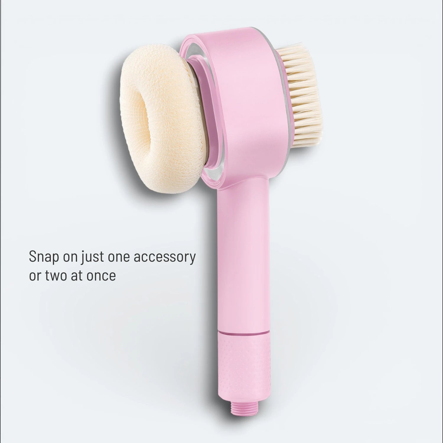 A shower head with attached magnetic snap-on exfoliating sponge and soft brush on a light gray background #Color=Pink