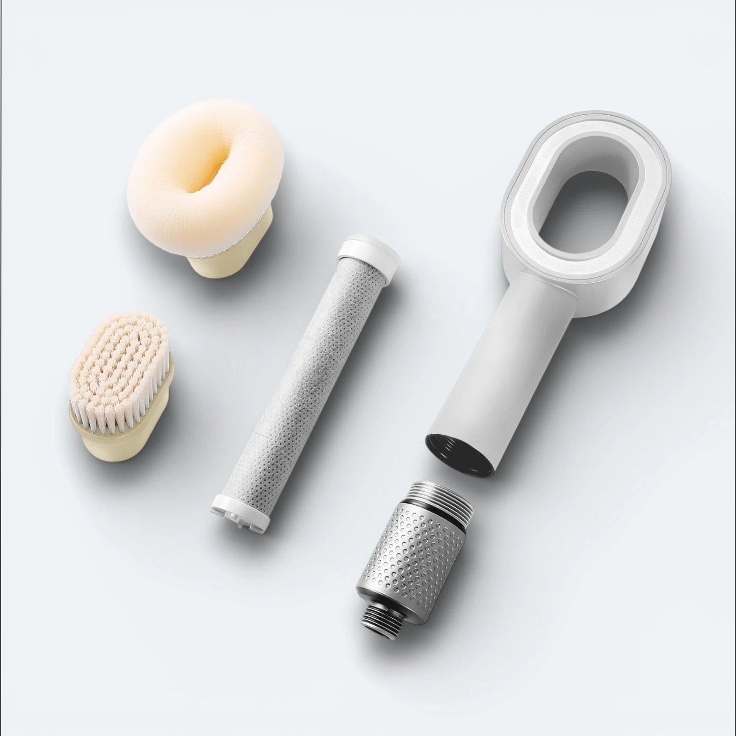 Collection of grooming tools including a shower head, filter, sponge, and brush, on a light blue background #Color=Light Bronze