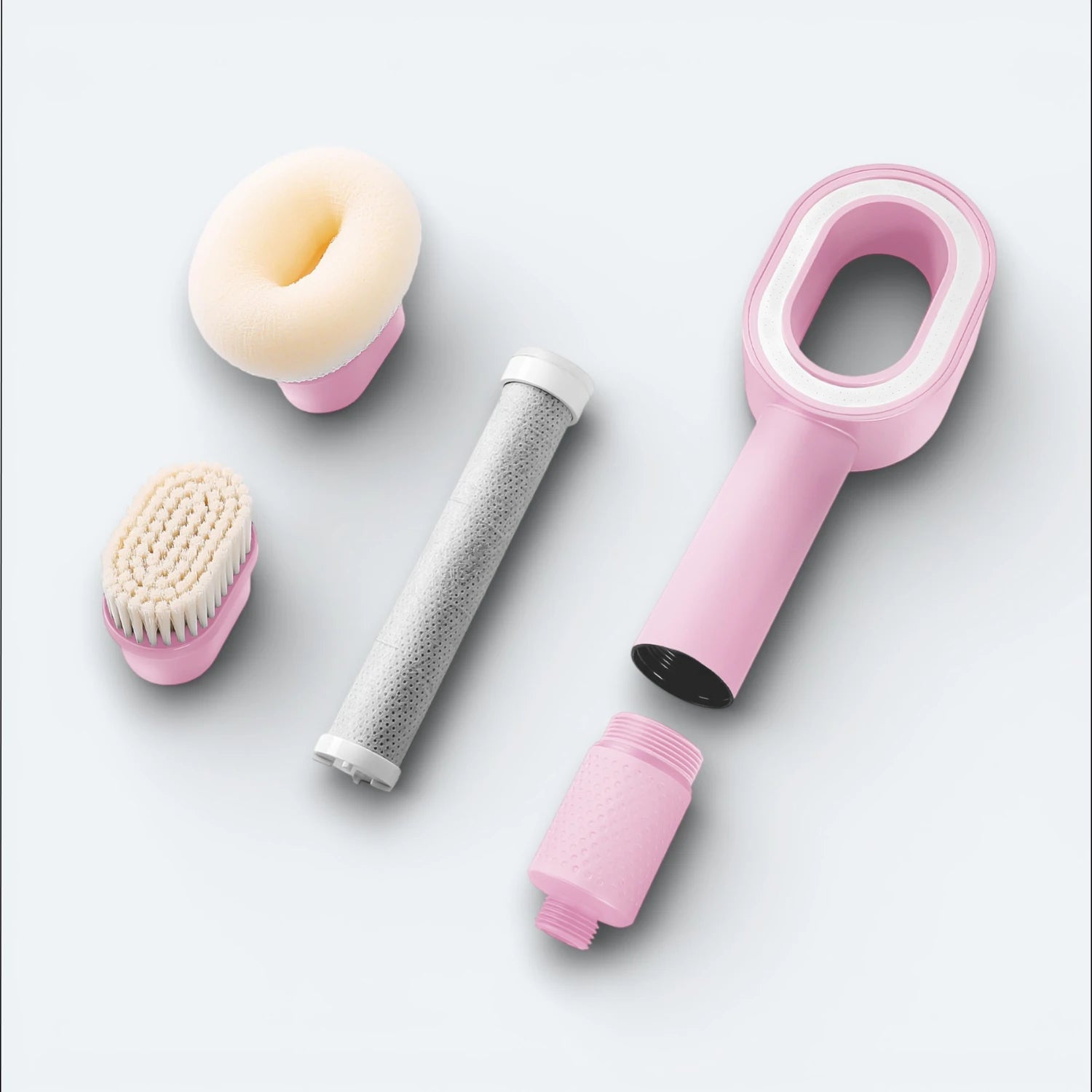 Collection of grooming tools including a shower head, filter, sponge, and brush, on a light blue background #Color=Pink